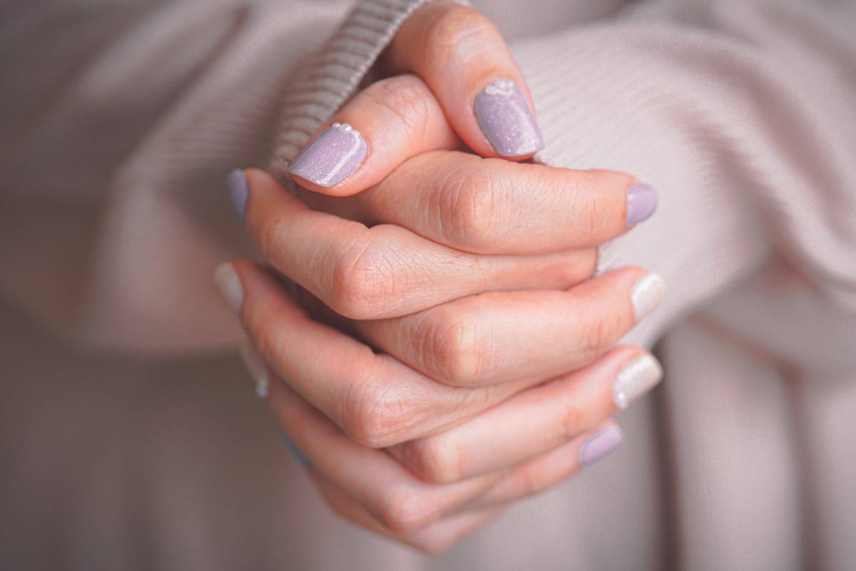 minimalist nail designs featuring clean white lines on nude base with negative space